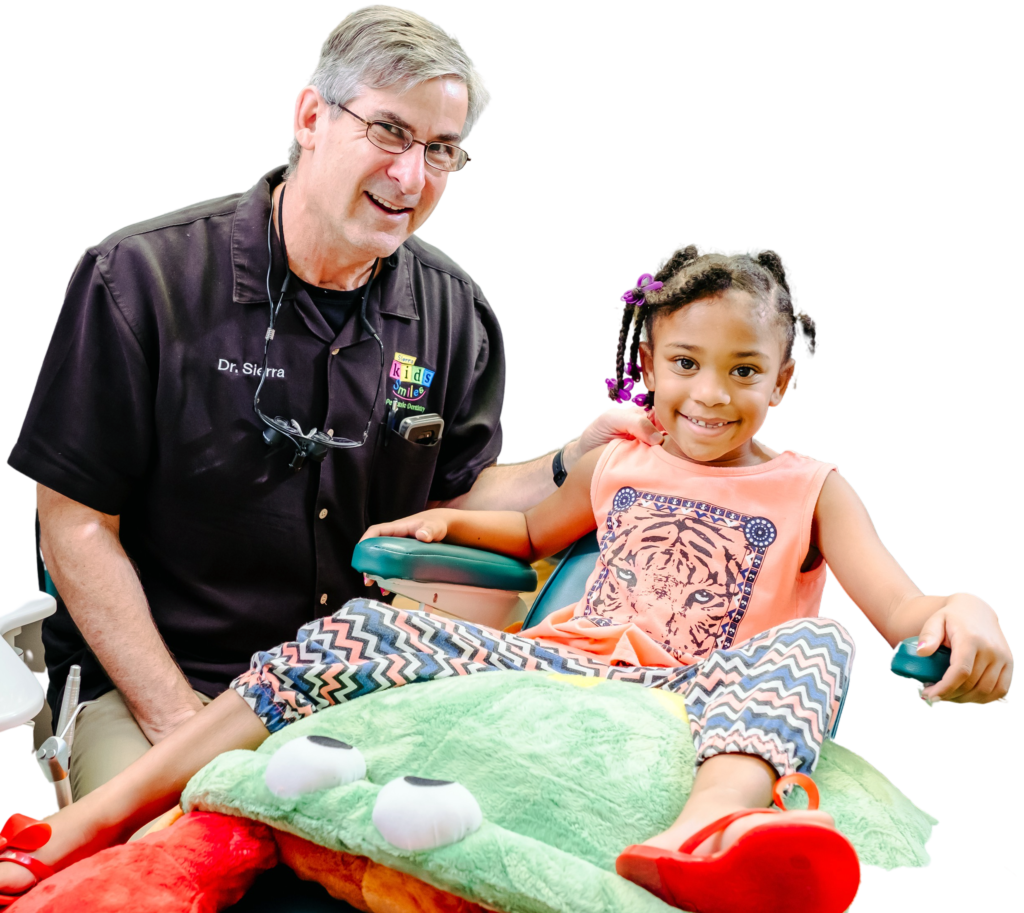 Dr. Sierra smiles with pediatric dental patient
