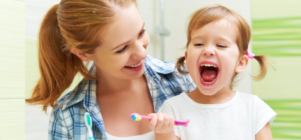 mom learns about baby bottle tooth decay while holding daughter