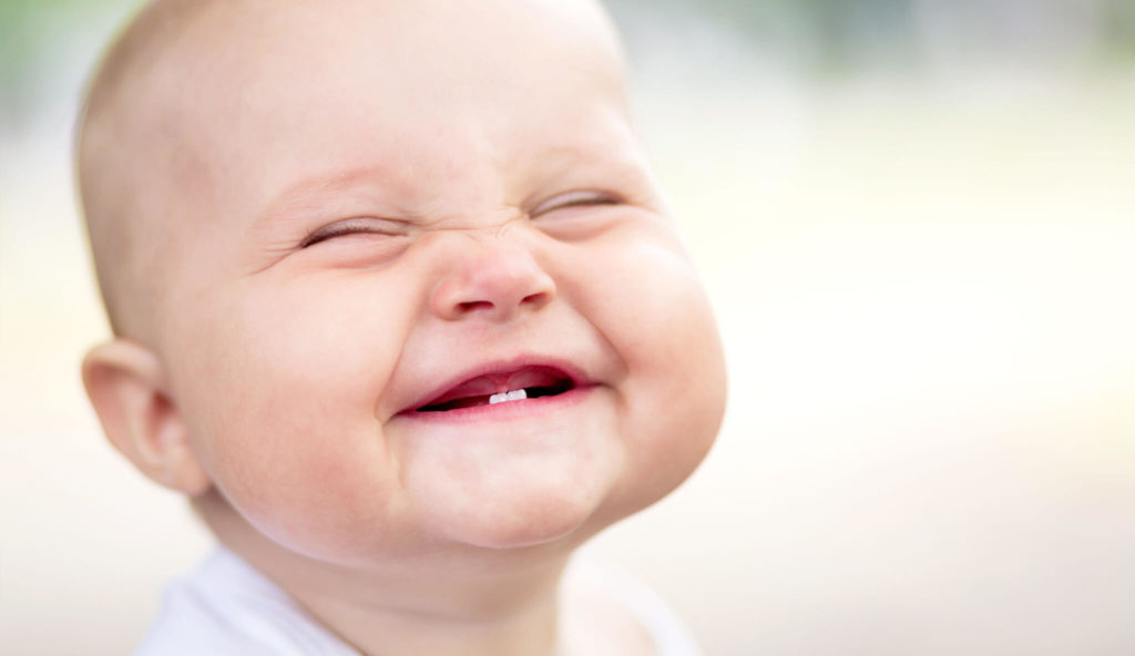 smiling baby with only 2 teeth
